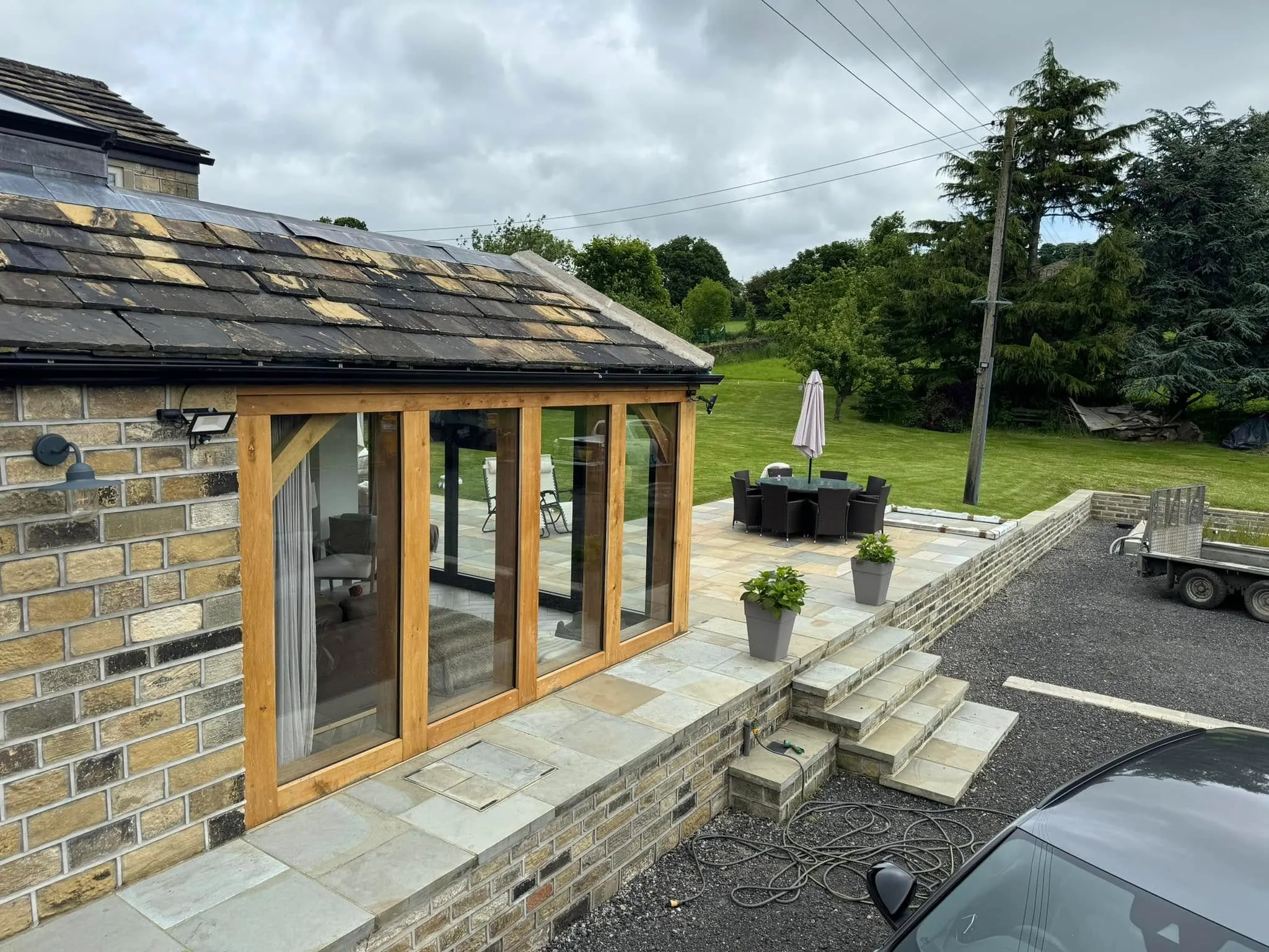 A building with a patio and a car parked in front of it.